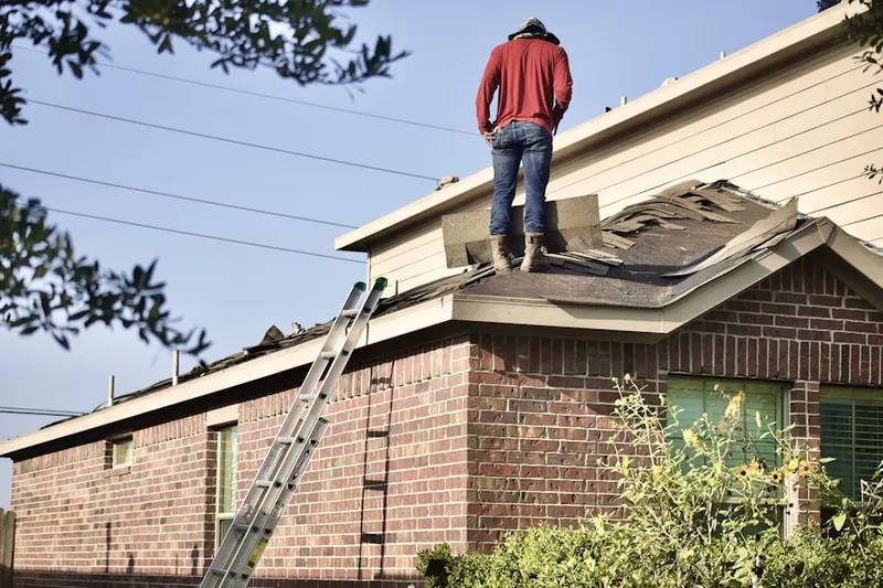 Professional roofer working on a residential roof in The Champions Club